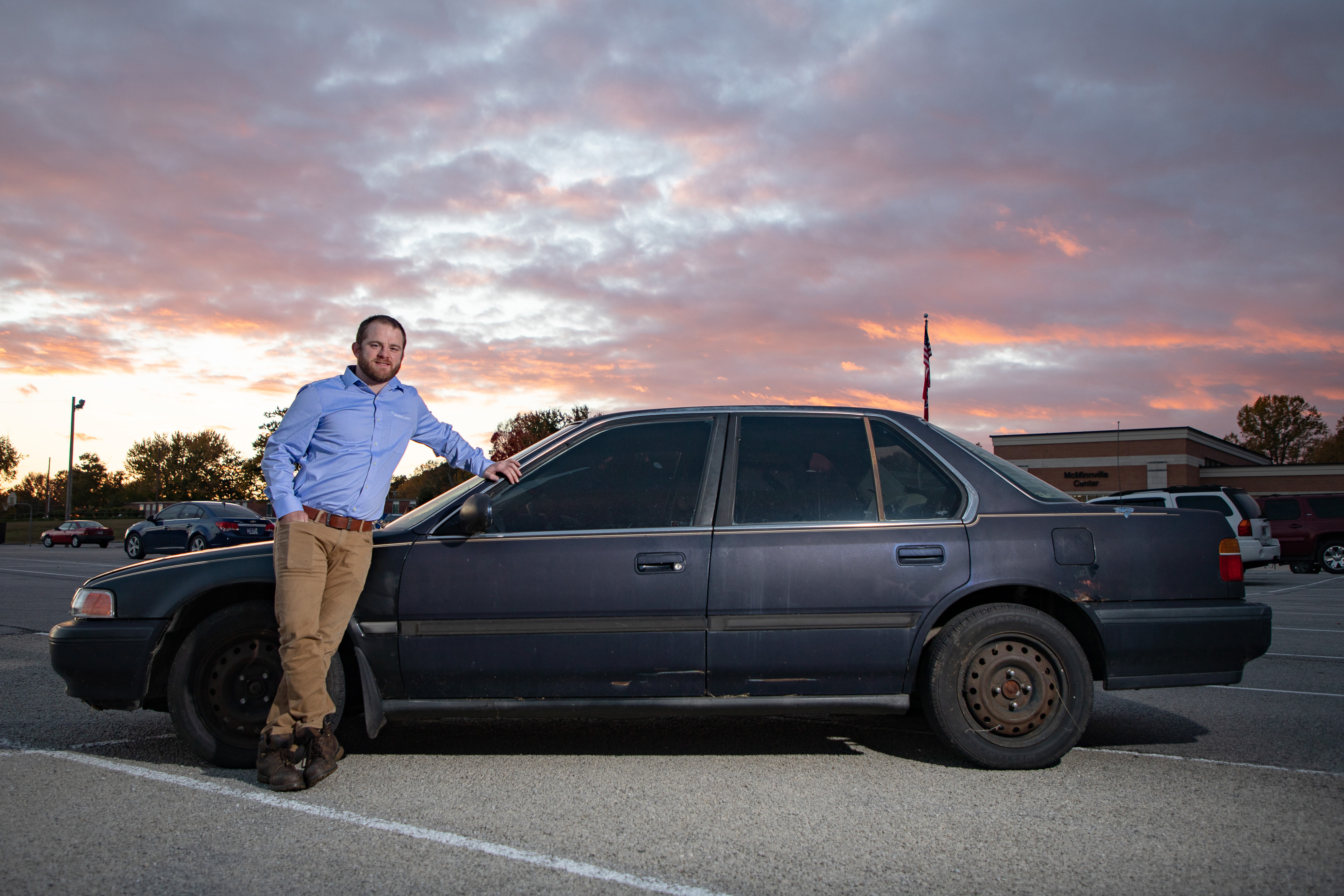 Motlow Mechatronics graduate LeGrand Sommers stands beside his car outside the McMinnville campus.