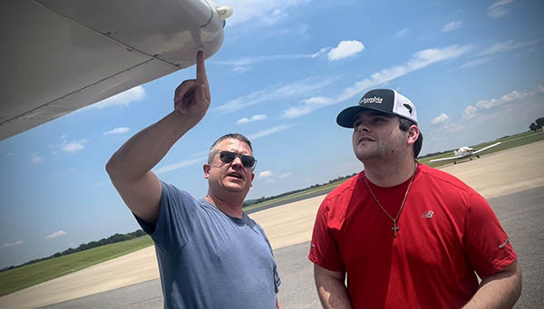 Washburn (left) giving a lesson about aircraft.