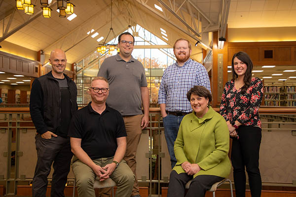 Pictured, left to right – back row: Christian O’Grady - Videographer / Photographer and Digital Media Specialist, Kyle Henn - Graphic Designer and Marketing Specialist, Andrew Lamb - Digital Marketing Content Specialist, Sarah Raymond - Staff Writer. Front row: Davis Seal - Director of Operations and Dr. Terri Bryson - Vice President of External Affairs. 