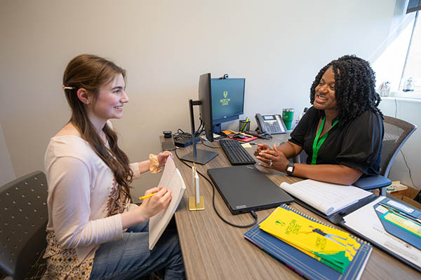 Dr. Erica Lee, Director of Recruitment, meets with student to provide academic advisement.