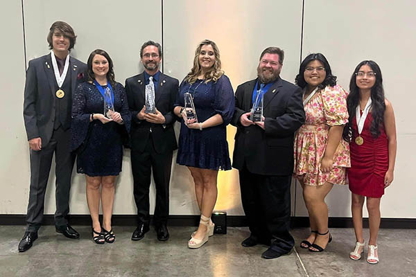 Pictured, from left to right: Raymond Morton, Dayron Deaton-Owens, Gregg Garrison, Misty Griffith, Rob Keel, Ashley Portillo, and Alejandra Sofia Amaya at the 2023 PTK International Convention where they received awards for the Mental Health Education Project as well as other works.