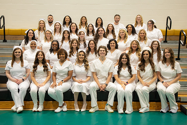 A group of Motlow State nursing graduates pose for a picture while wearing all white