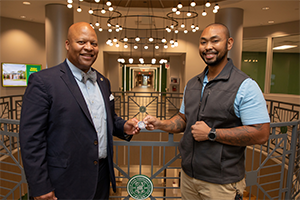 Motlow President, Dr. Michael Torrence (left) presents the Chancellor’s Commendation coin to student Adam Boyd on behalf of Tennessee Board of Regents (TBR) Chancellor Flora W. Tydings.