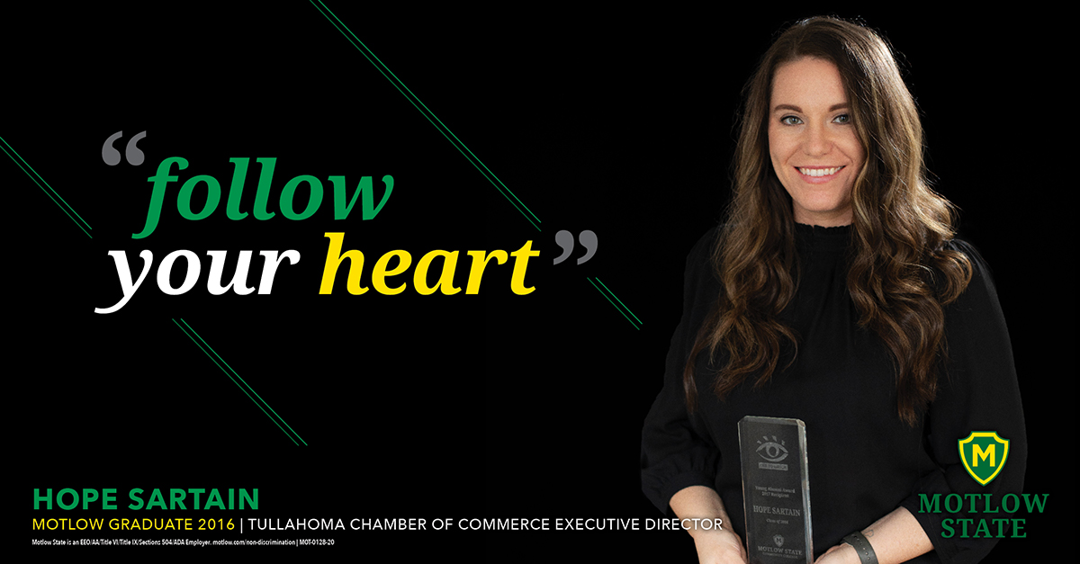 graduate Hope Sartain holding an award