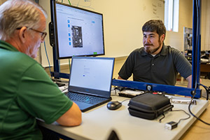 Motlow student Josh Scott, right, talks to Motlow’s Head of Prior Learning Assessments (PLAs) Walter McCord. Scott earned credit at the College for his knowledge in the IT career field he gained while serving in the U.S. Navy.